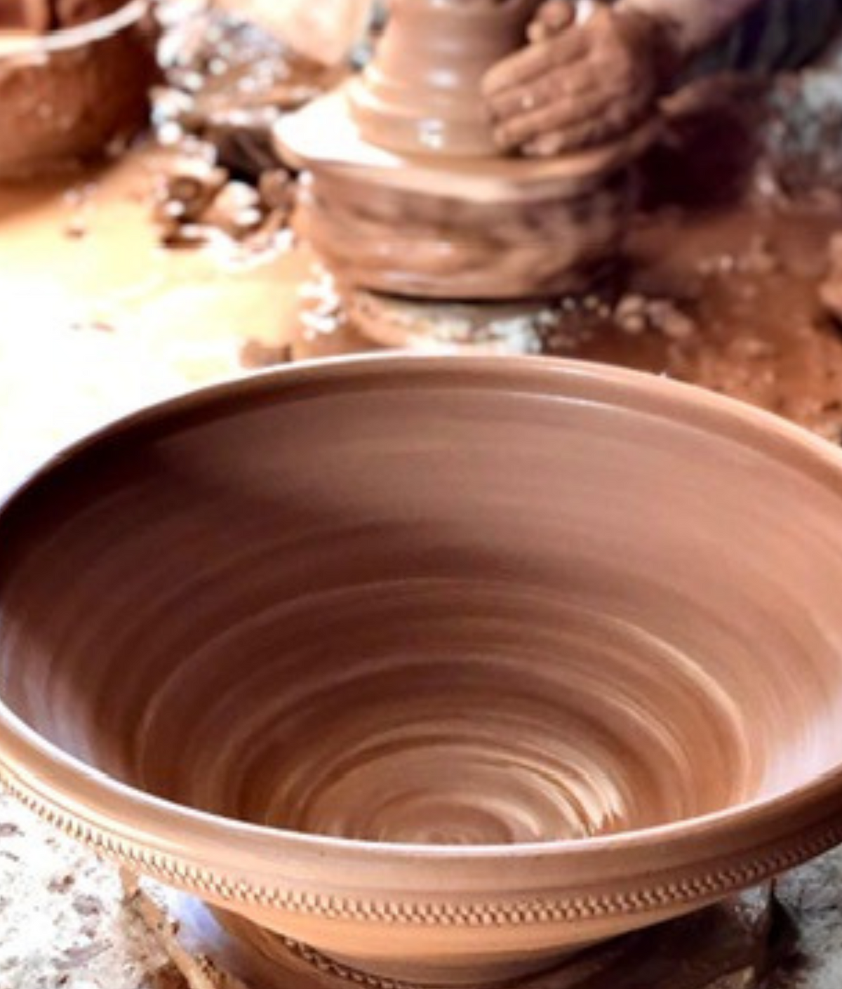 At the potter’s wheel.
